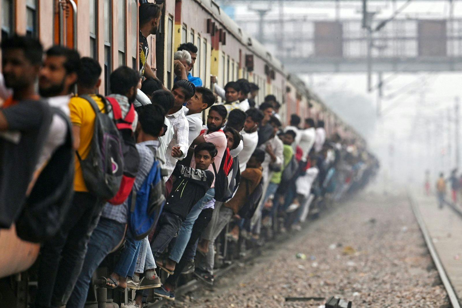 Commuters travel in an overcrowded train near a railway station at Loni town in India's state of Uttar Pradesh on April 24, 2023 (ARUN SANKAR/AFP via Getty Images)