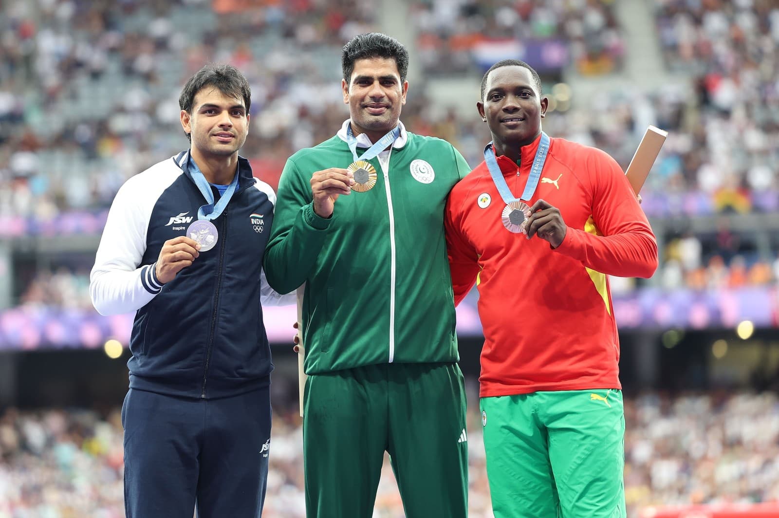 Gold medalist Arshad Nadeem (C) of Pakistan, silver medalist Neeraj Chopra (L0L of India and bronze medalist Anderson Peters of Grenada react during the victory ceremony of the men’s javelin throw of Athletics at the Paris 2024 Olympic Games in Paris, France, Aug. 9, 2024 (Li Ying/Xinhua via Getty Images)